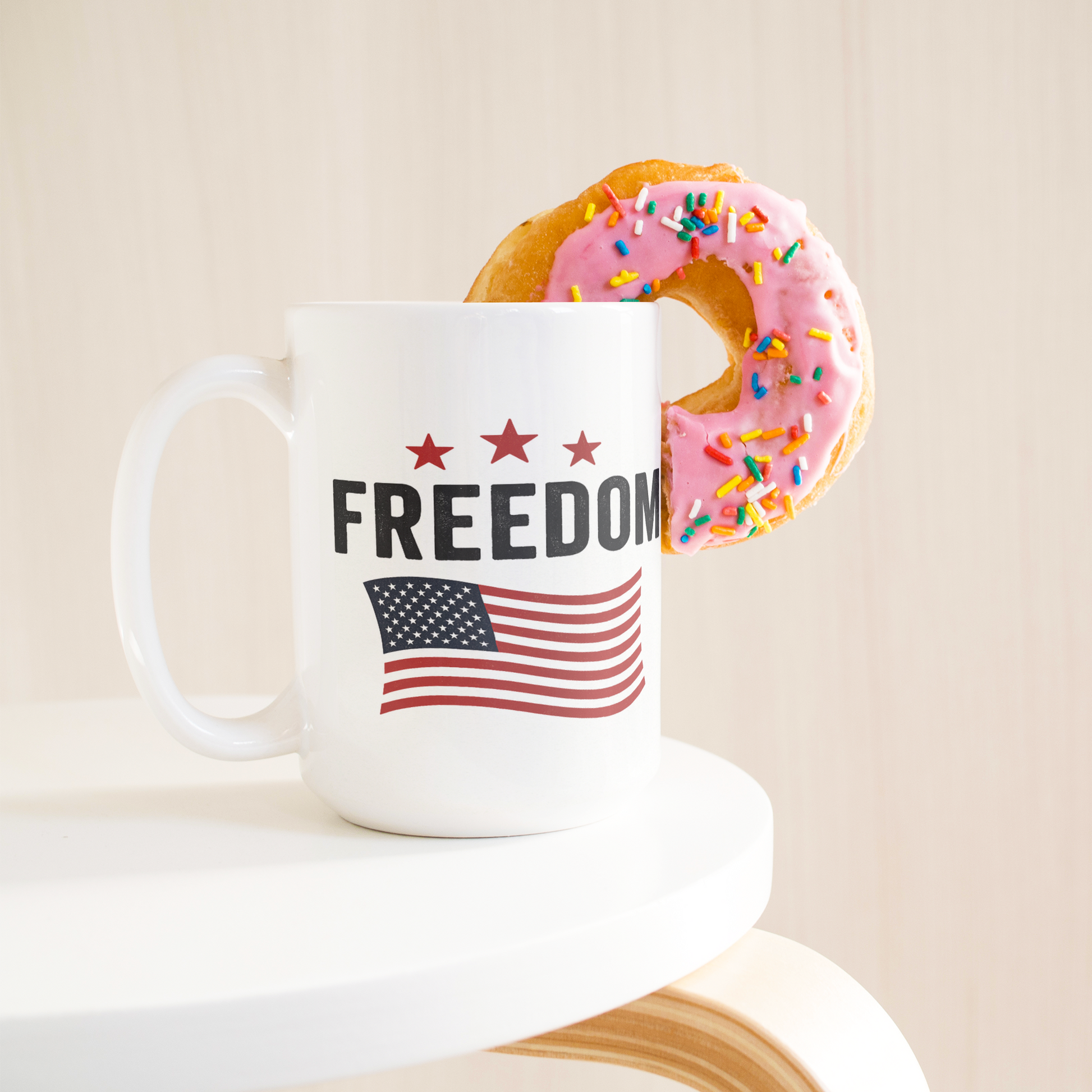 Freedom_15oz_Patriotic_Mug_15ozWhiteMugLifetsyleDonutLH_Mockup.png