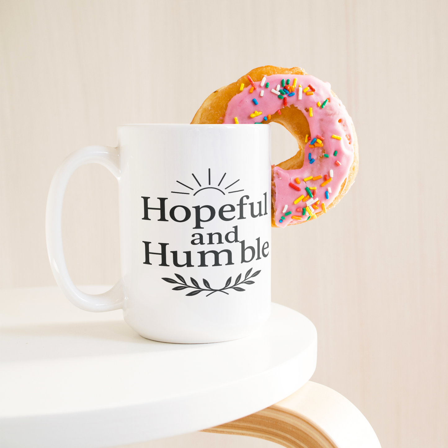 Hopeful_and_Humble_Mug_15ozWhiteMugLifetsyleDonutLH_Mockup.png