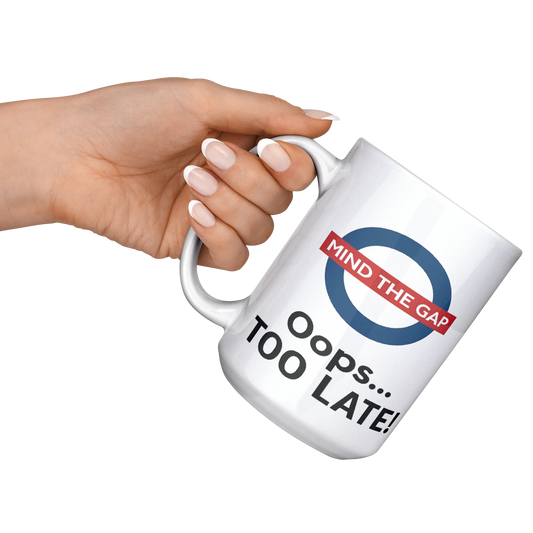 Mind_the_Gap_Oops_Too_Late_Funny__15ozWhiteMugLifestyleLHRaisedAngle_Mockup.png