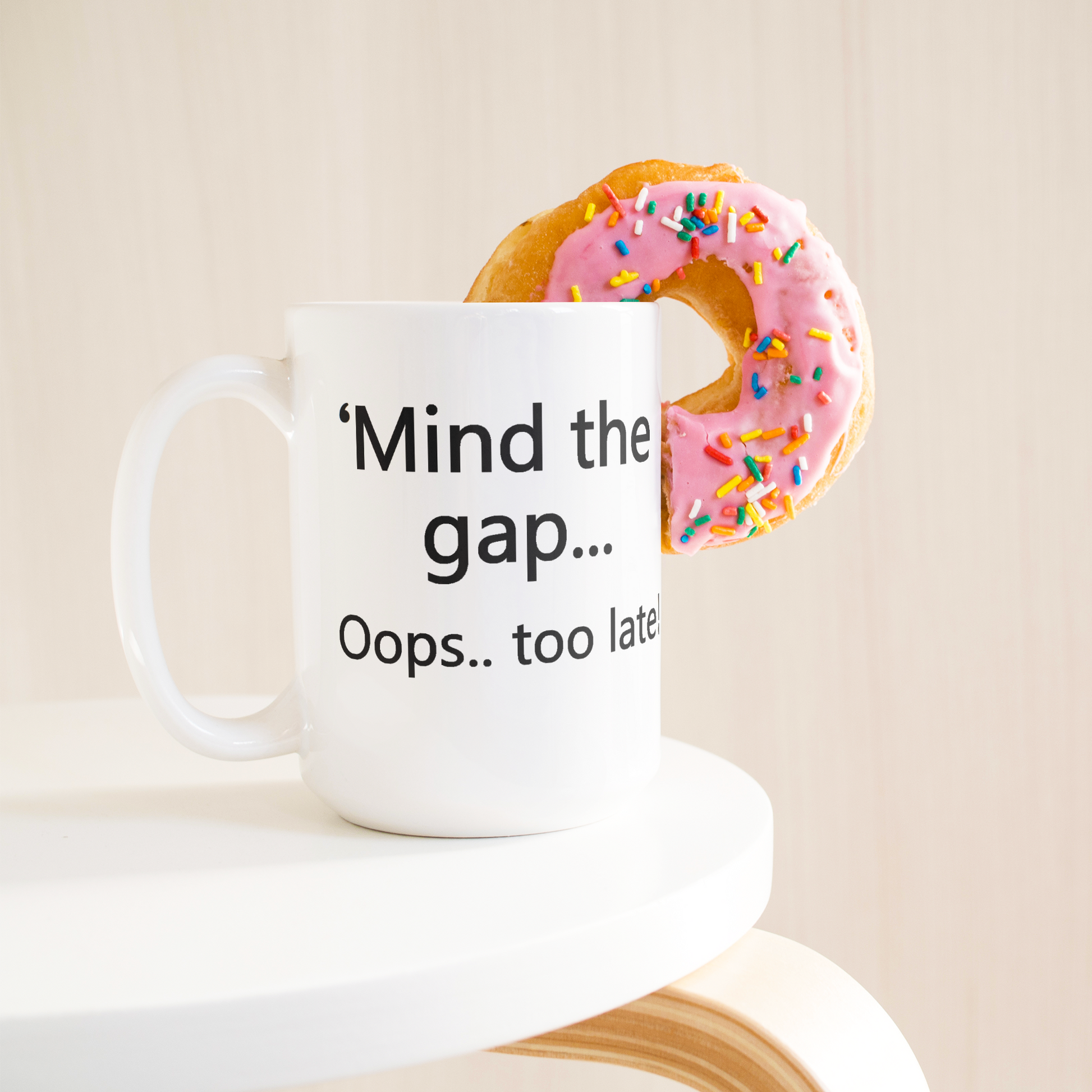 Mind_the_Gap__Oops_Too_Late_Funny_Br_15ozWhiteMugLifetsyleDonutLH_Mockup.png