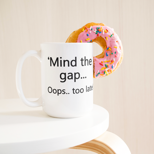 Mind_the_Gap__Oops_Too_Late_Funny_Br_15ozWhiteMugLifetsyleDonutLH_Mockup.png